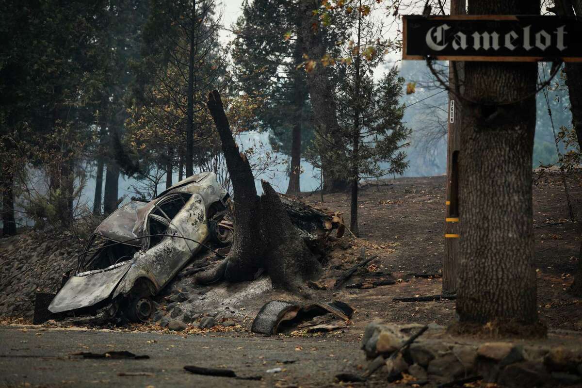 A car is seen burned on the side of Concow Road following the Camp Fire in Concow, California, on Tuesday, Nov. 13, 2018.
