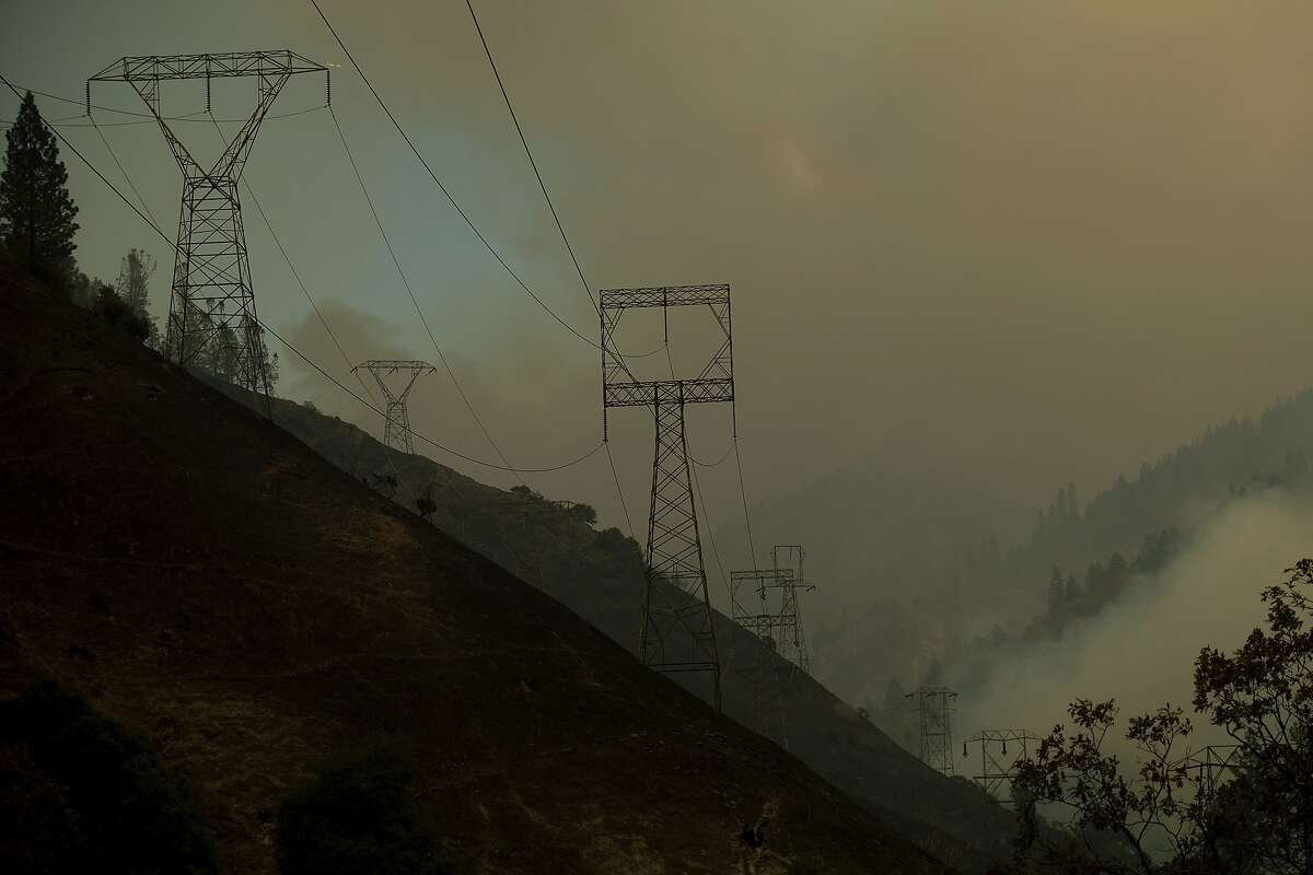 Power transmission lines crest a hilltop above Camp Creek Road, the point of origin of the Camp Fire, in Pulga, Calif., on Sunday, Nov. 11, 2018. (AP Photo/Noah Berger)