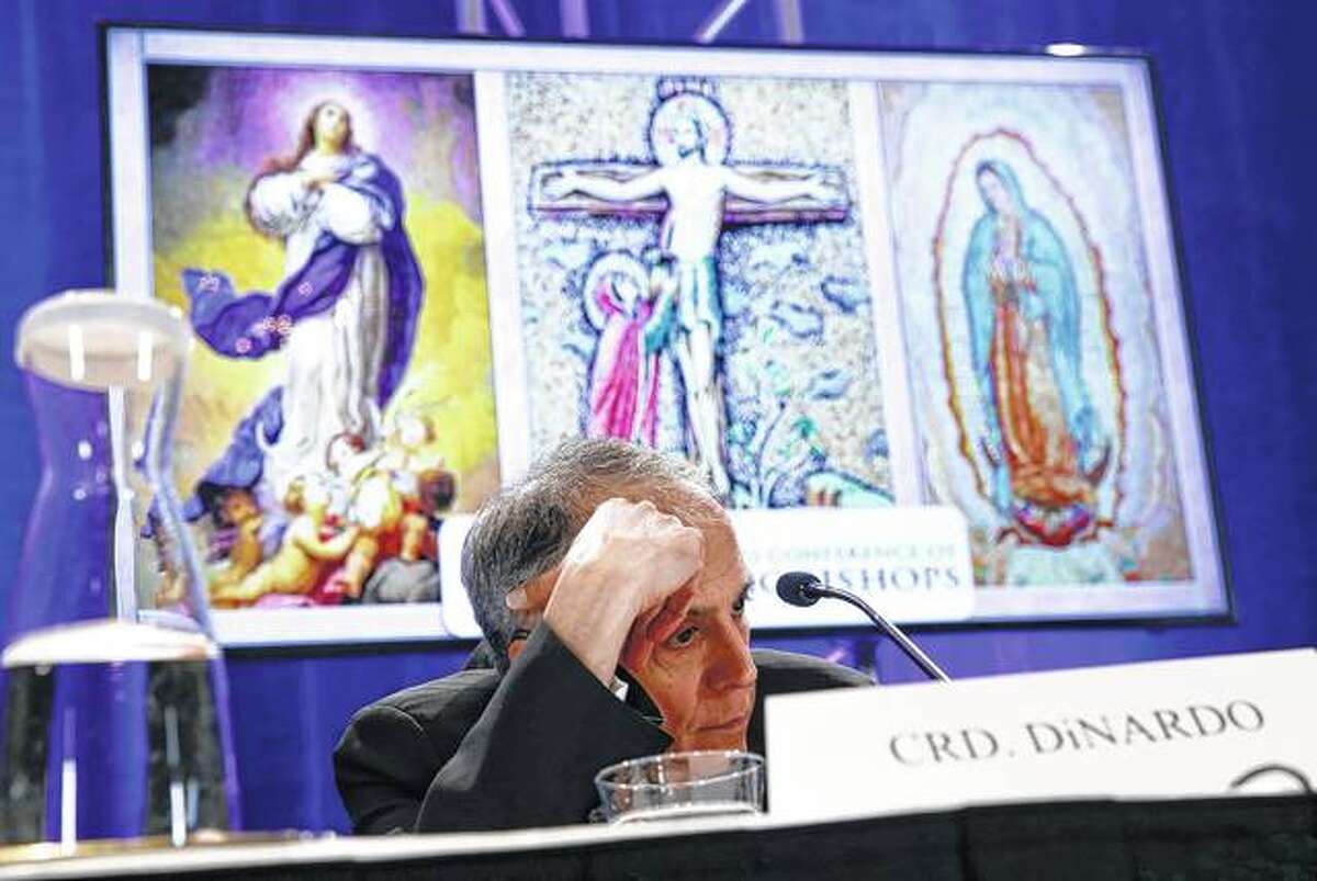 Cardinal Daniel DiNardo of the Archdiocese of Galveston-Houston, president of the United States Conference of Catholic Bishops, sits in a news conference Monday during the USCCB’s annual fall meeting in Baltimore.