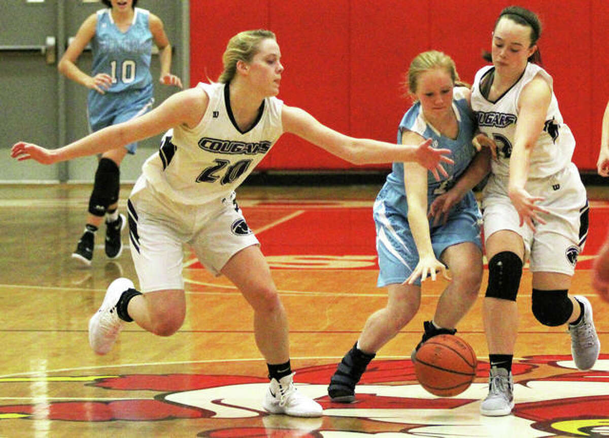 Jersey’s Sally Hudson (middle) dribbles through defensive pressure during the second half of the Panthers’ victory over Breese Central on Tuesday in the Alton Tip-Off Classic at Alton High in Godfrey.