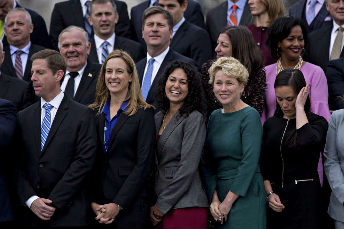 Member-elects of the 116th Congress wait for a group photo Wednesday outside the U.S Capitol in Washington, D.C. A spokeswoman for the Committee on House Administration says it allows candidates in undecided races, such as Gina Ortiz Jones, far right in bottom row, “to participate in all of the official programming.”