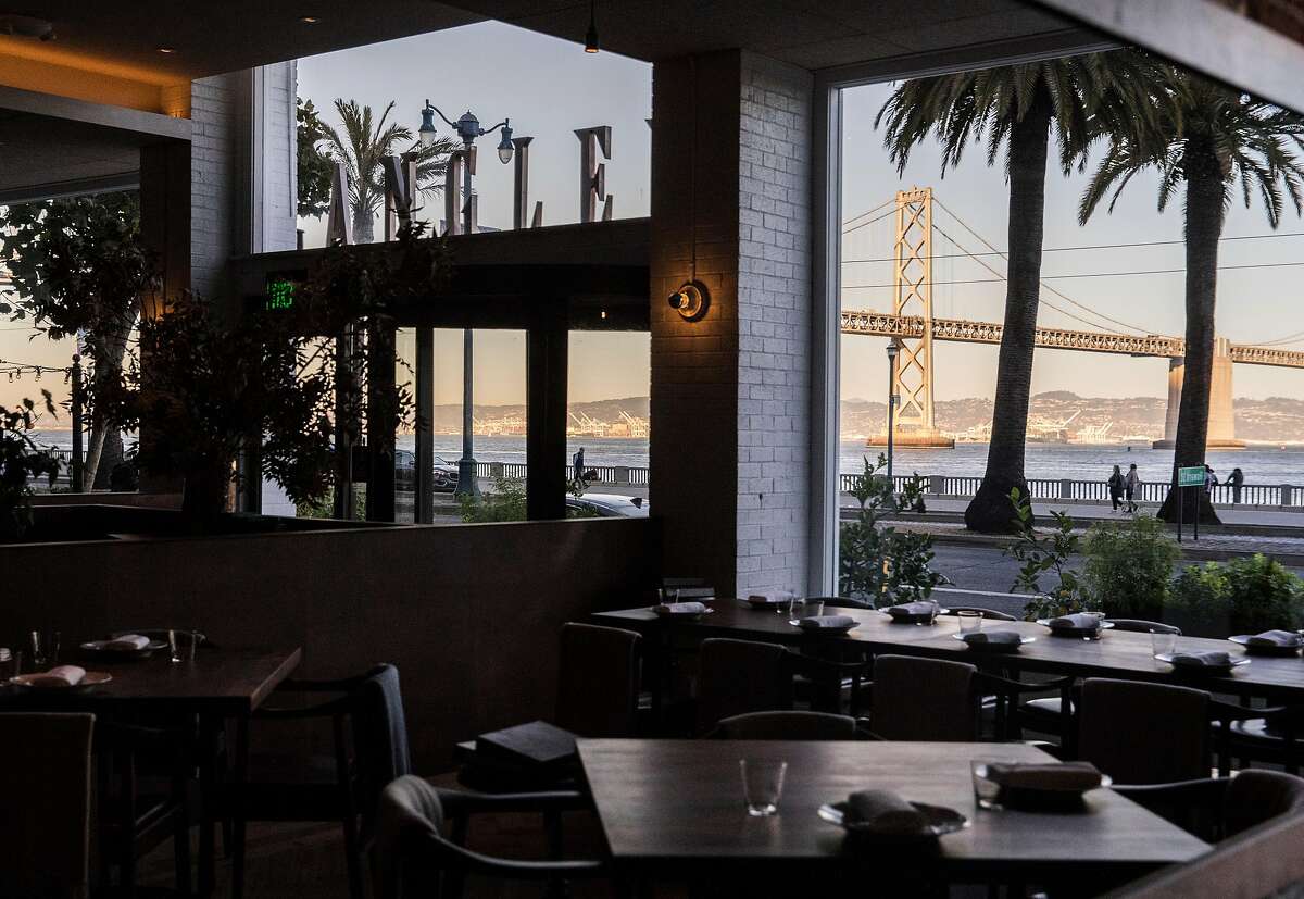 The Bay Bridge is seen through the windows of the main dining room inside Angler along the Embarcadero in San Francisco, Calif. Wednesday, Nov. 7, 2018.