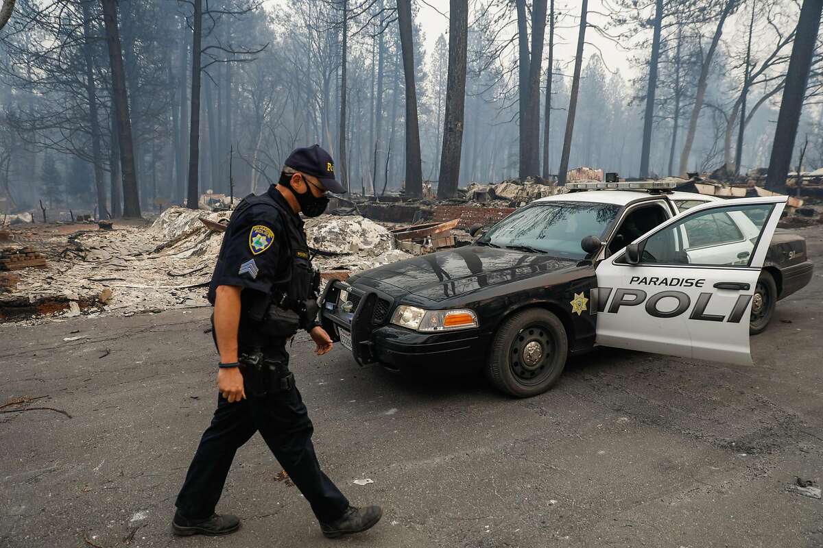 Sgt. Robert Pickering goes back to his cop car while patrolling on Libby Road following the Camp Fire in Paradise, California, on Wednesday, Nov. 14, 2018.