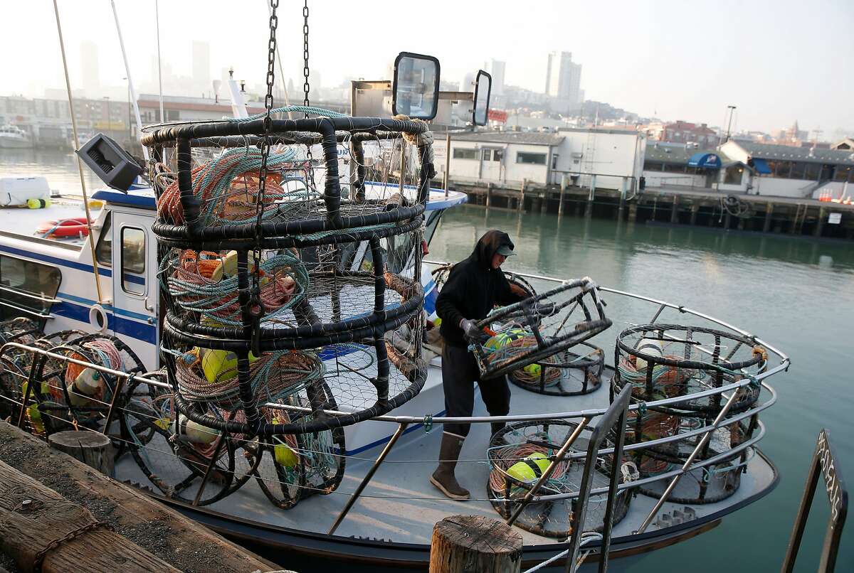 Matt Zidek stacks crab pots on the deck of the New Rayann fishing boat at Pier 45 for the opening of the commercial crab season in San Francisco, Calif. on Wednesday, Nov. 14, 2018.