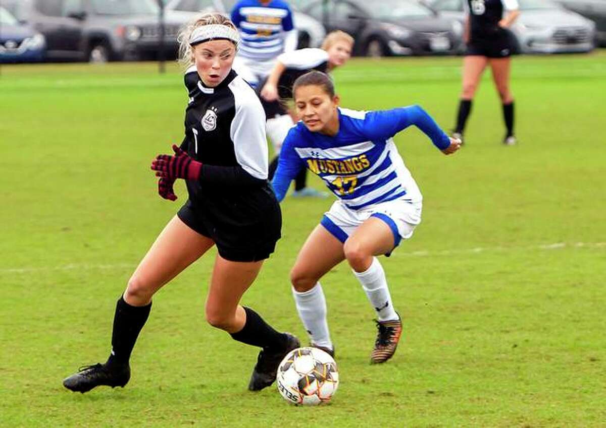 Lewis and Clark’s Megan Pierce (5) controls the ball against Monroe’s Angie Ponce in Wednesday’s pool play game at the NJCAA National women’s Soccer Championships in Foley Ala. Monroe won 4-1, ending LCCC’s season at 19-1.