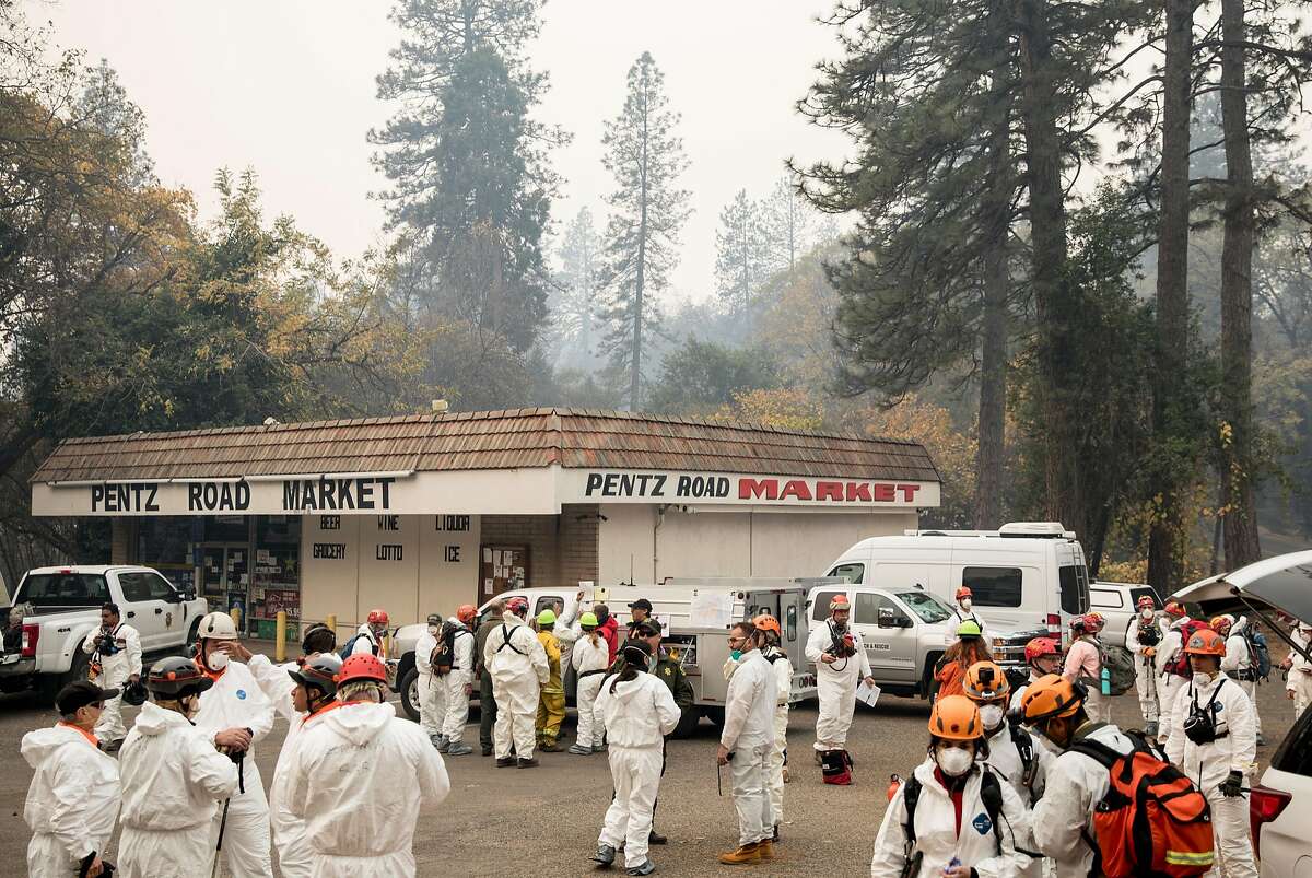 Search and Rescue teams as well as forensics and archaeologists gather near Pentz Road Market before heading out to search through the rubble of homes for victims in Paradise, Calif. Wednesday, Nov. 14, 2018 after the Camp Fire ripped through the entire town.