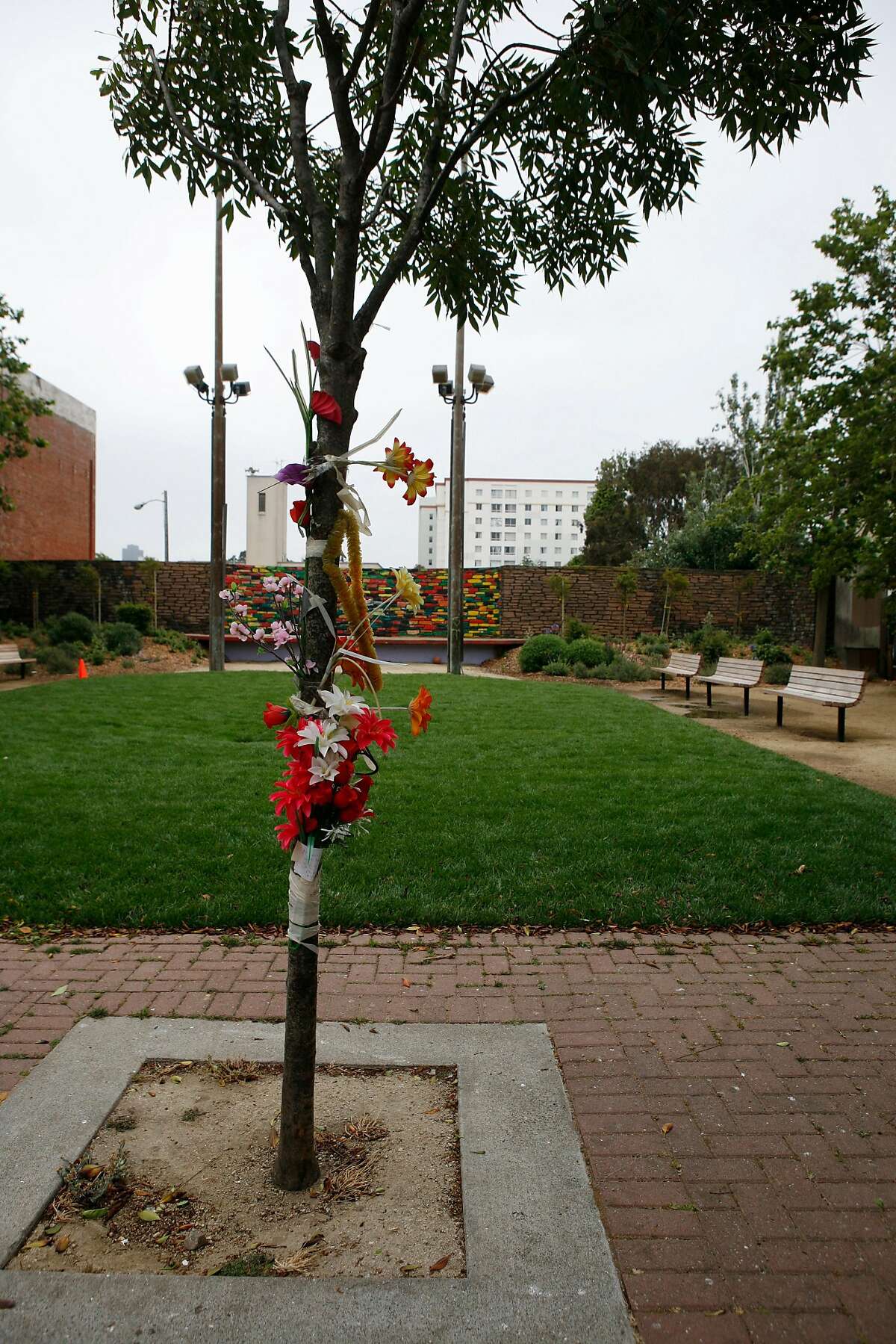 Memorial flowers at the Fillmore-Turk mini park in San Francisco in 2008. Under the current plan for park renovations, there will be a memorial wall for the Jonestown victims in the park.