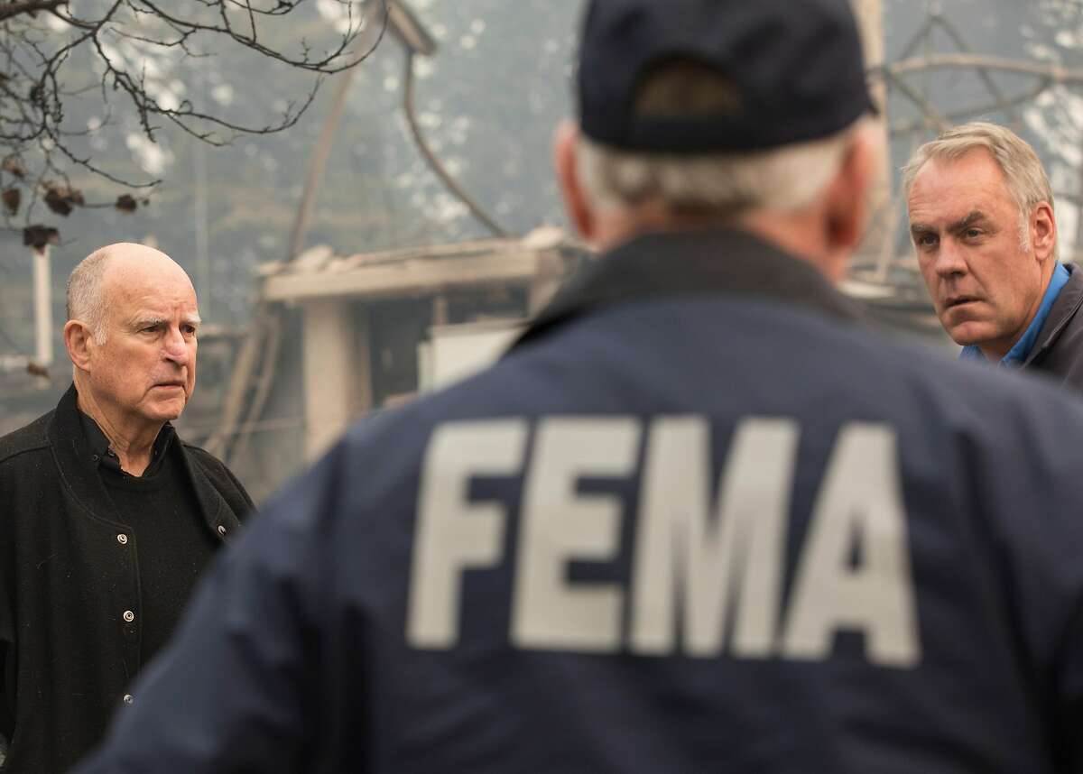California Governor Jerry Brown (left) and U.S. Secretary of the Interior Ryan Zinke tour the rubble of Paradise Elementary School in Paradise, Calif. Wednesday, Nov. 14, 2018 after the Camp Fire destroyed the school and most of the town.