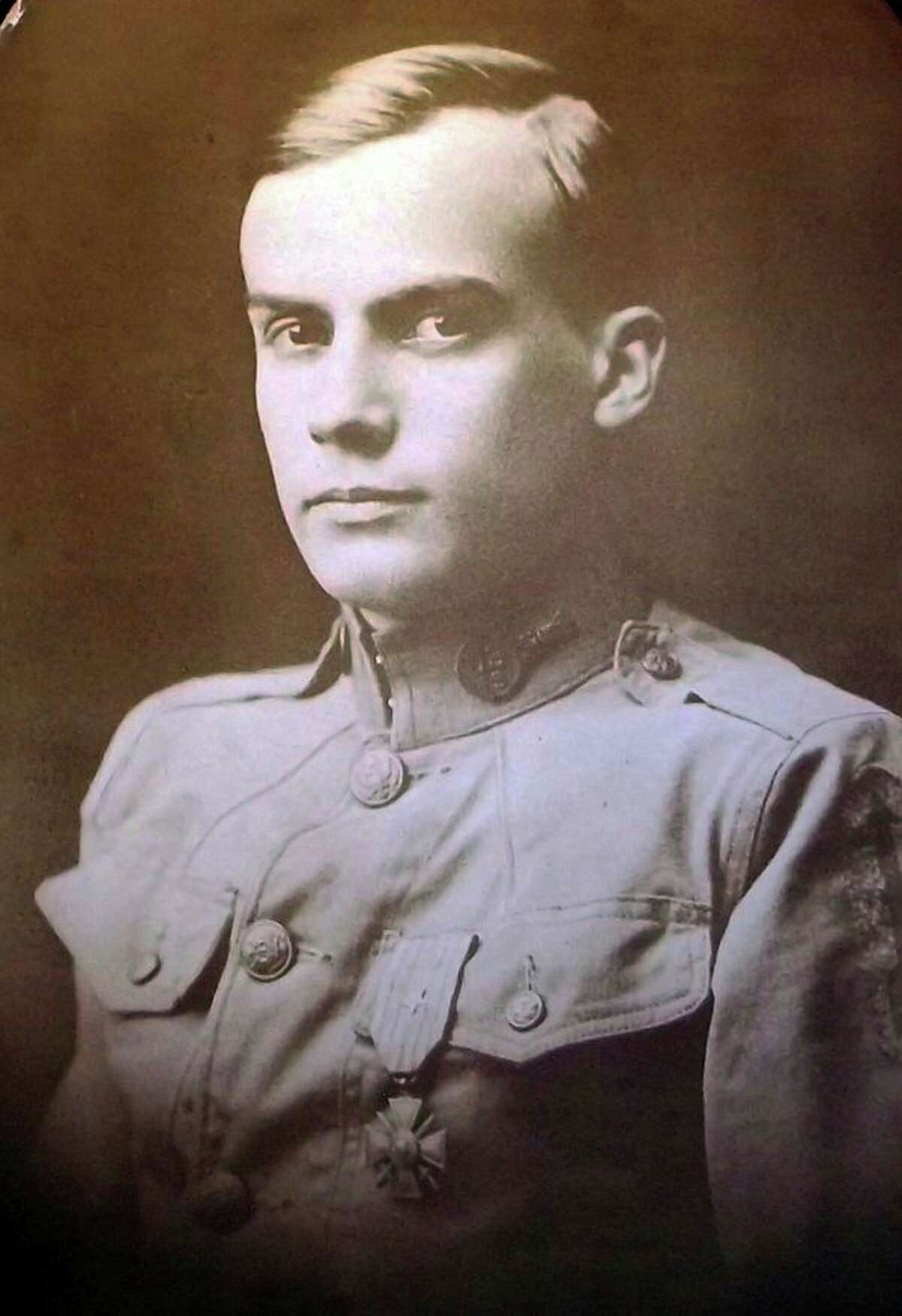 Alva Henry Cook poses for a formal portrait in his World War I uniform. As a 'runner' delivering messages on the battlefield, he saved a platoon commander and his 27 men from carrying out an order to attack the enemy. He received the Croix de Guerre for this action.