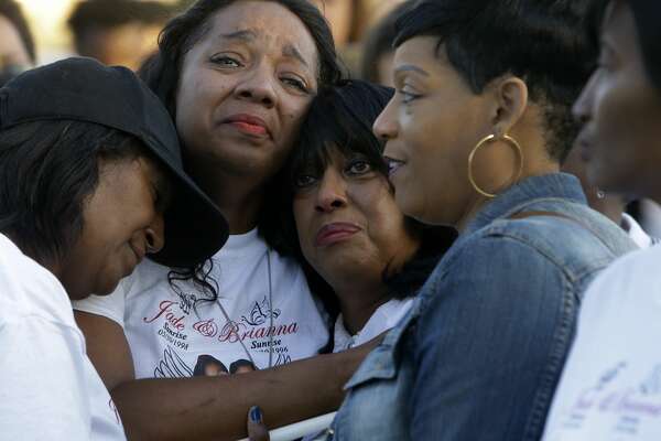 Stacey Robinson, second from left, is consoled as she attends a memorial in Houston in 2016 honoring her two daughters who died in a spring break crash in Corpus Christi.