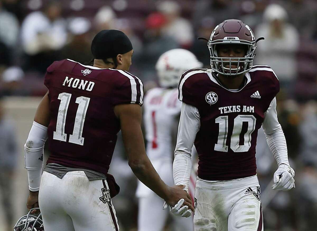 Myles Jones (10)of the Texas A&M Aggies receives a handshake from Kellen Mond (11) after he was ejected from the game for targeting in the fourth quarter against the Mississippi Rebels at Kyle Field on November 10, 2018 in College Station, Texas.