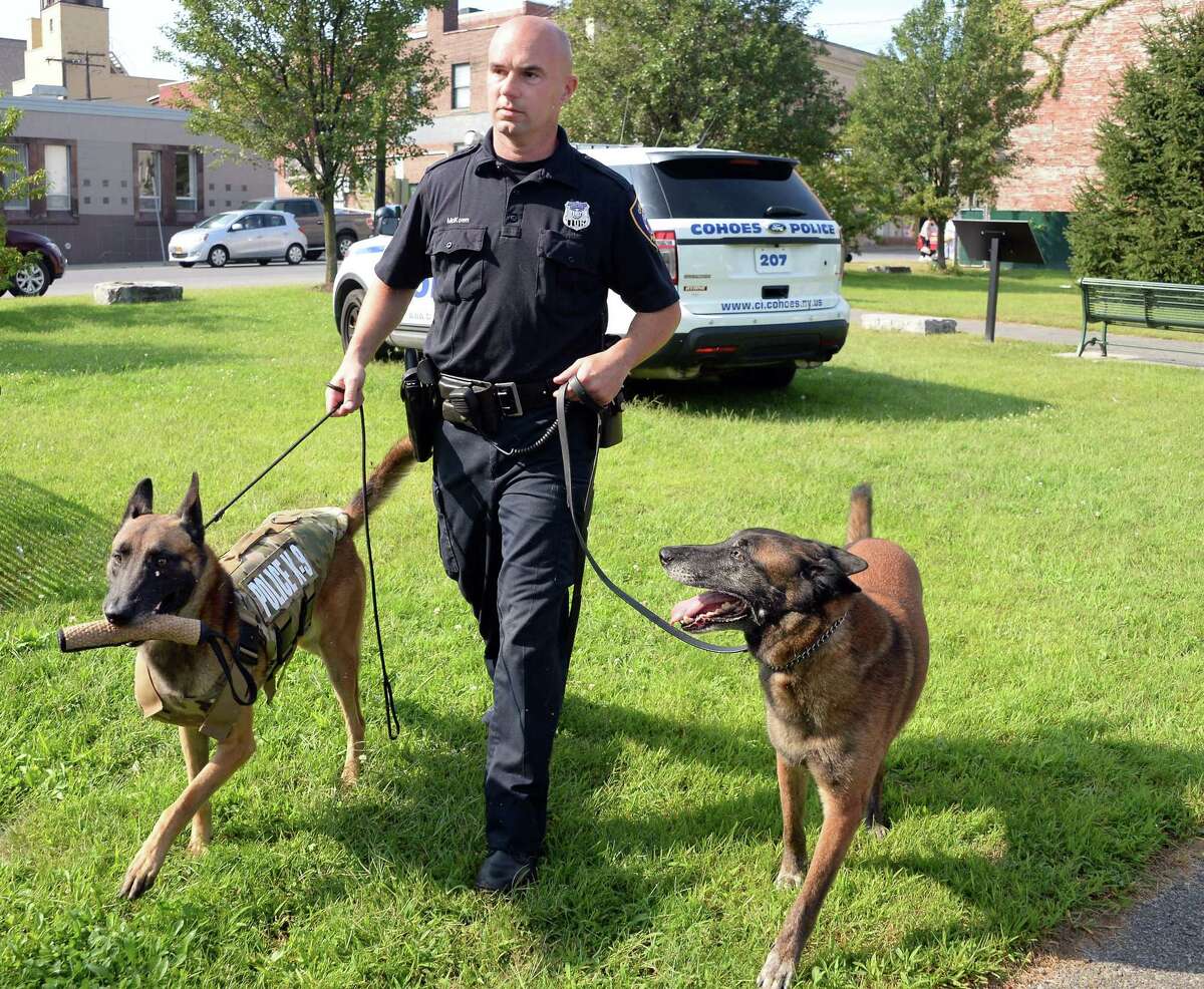 Officer and K-9 handler Sean McKown, with retiring K-9 Jeter, right, and Jeter's son and replacement Loky outside the Cohoes Police Station Wednesday Sept. 9, 2015 in Cohoes, NY. (John Carl D'Annibale / Times Union)