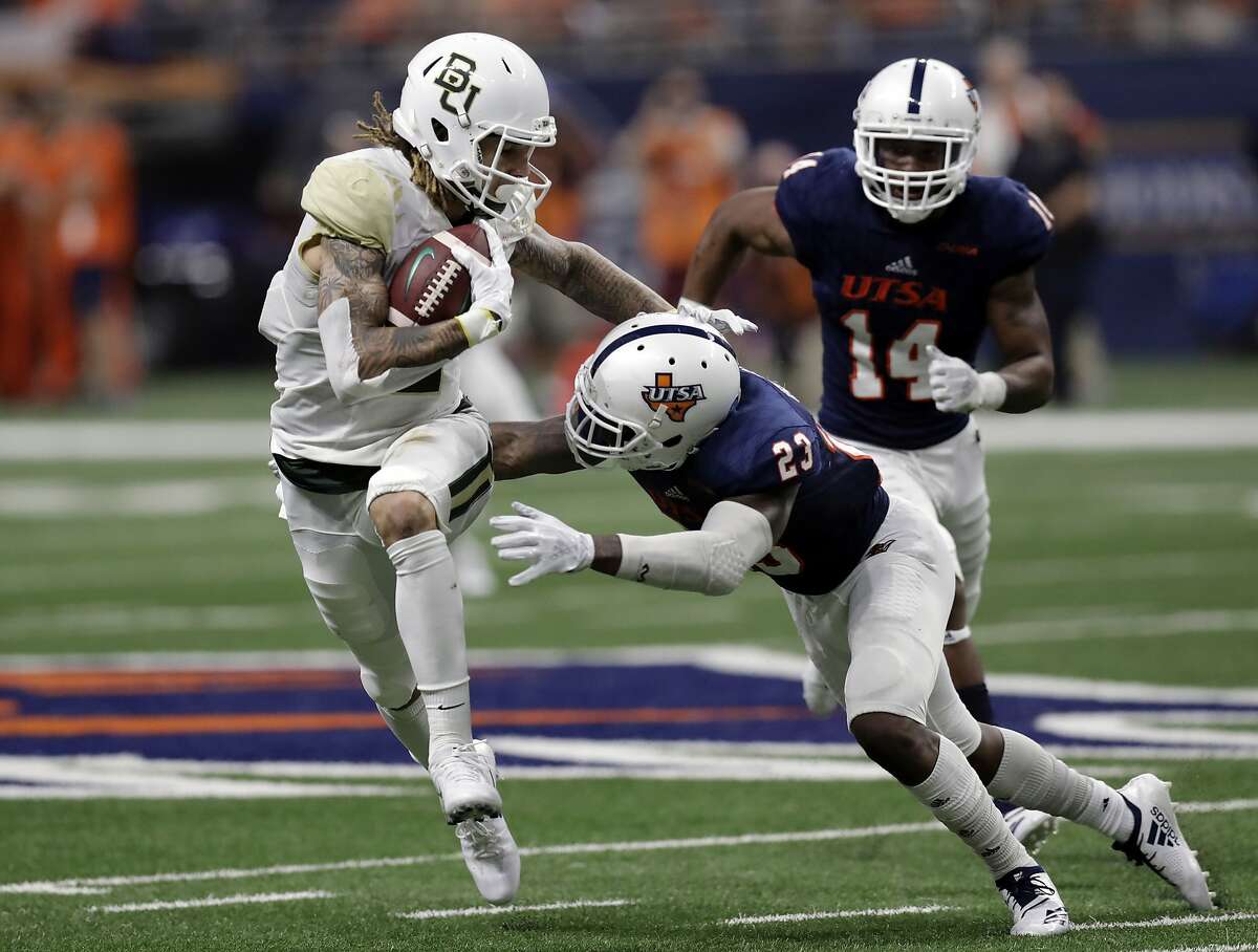 FILE - In this Sept. 8, 2018, file photo, Baylor wide receiver Jalen Hurd (5) tries to avoid a hit by UTSA safety Darryl Godfrey (23) following a catch during the second half of an NCAA college football game in San Antonio. Hurd made a thoughtful decision to become a receiver for one season at Baylor after being one of the top running backs in the SEC. Hurd’s transfer from Tennessee and transition to primarily catching the ball instead of carrying it has worked out with the Bears after going more than a year without playing a game. (AP Photo/Eric Gay, File)