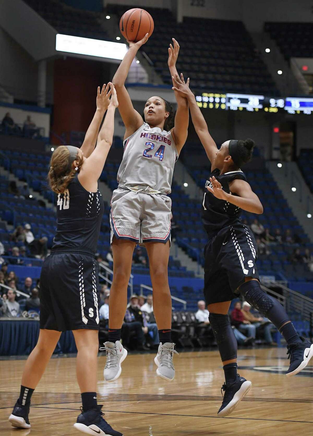 UConn’s Napheesa Collier, center, shoots as Southern Connecticut State’s Allie Smith, left and Imani Wheeler, right, defend on Thursday night in Hartford.