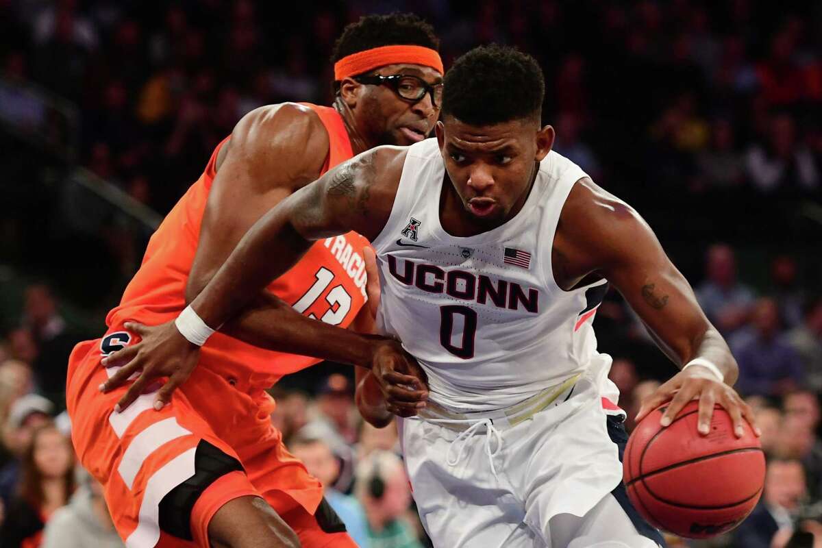 UConn’s Eric Cobb moves past Syracuse’s Paschal Chukwu in the first half of Thursday’s 2k Empire Classic game at Madison Square Garden in New York.