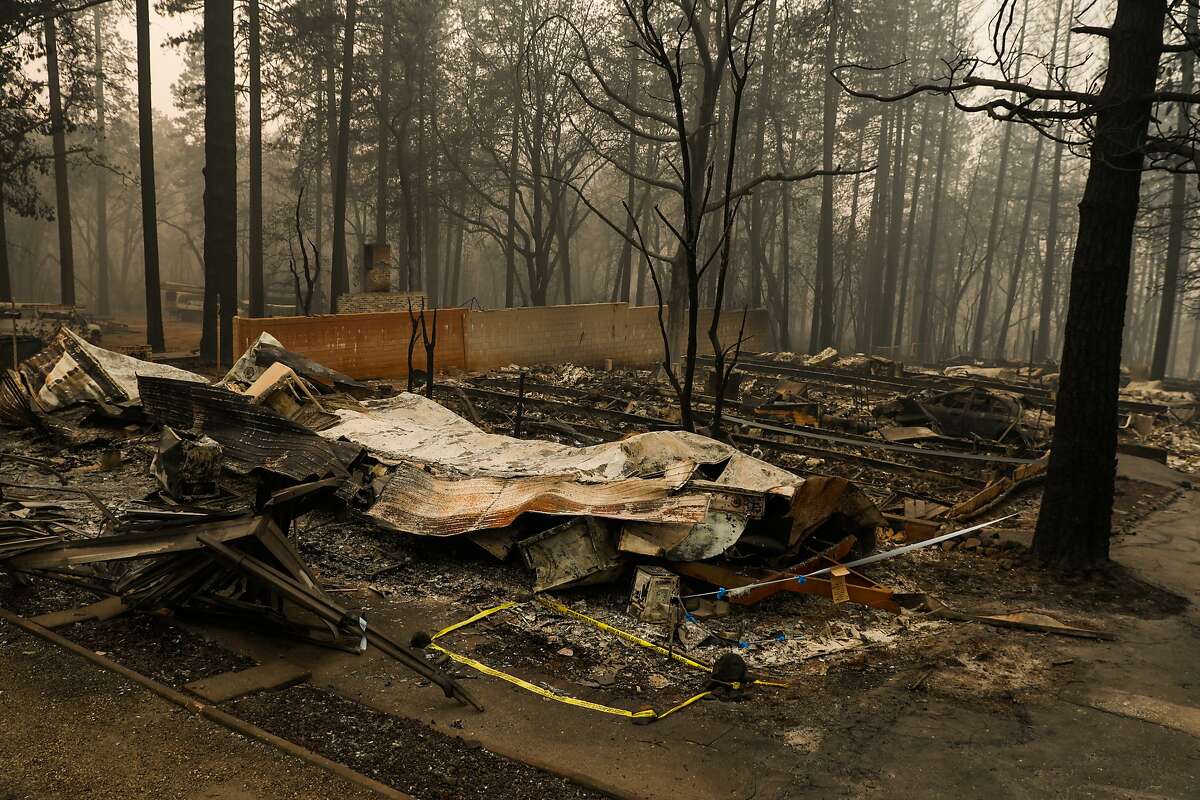 Caution tape is seen on a destroyed property where remains were discovered following the Camp Fire in Paradise, California, on Thursday, Nov. 15, 2018.