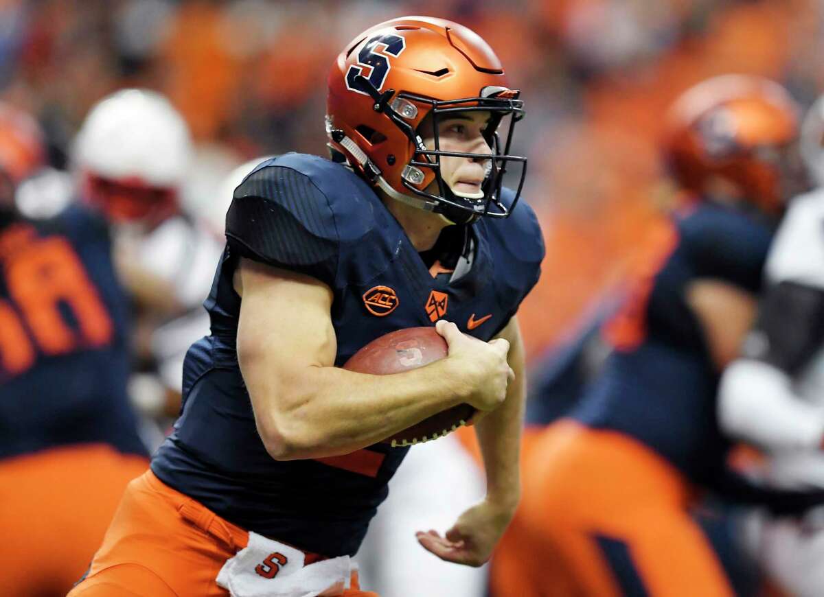 FILE - In this Nov. 9, 2018, file photo, Syracuse quarterback Eric Dungey runs with the ball during the first half of an NCAA college football game against Louisville in Syracuse, N.Y. Third-ranked Notre Dame will put its unbeaten record on the line when it faces No. 12 Syracuse at New York's Yankee Stadium on Saturday.