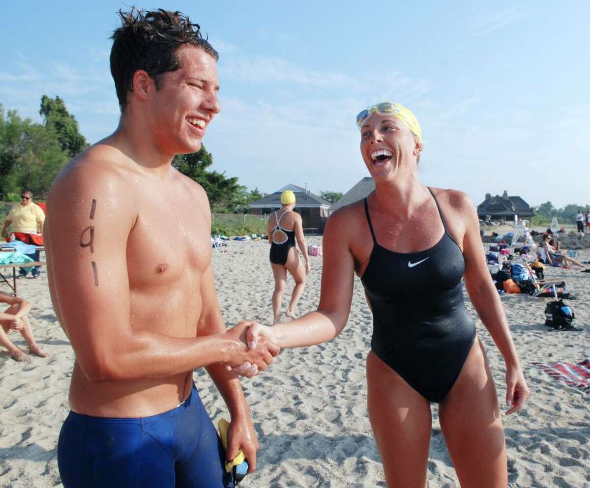 The Men's and Women's winners of the Greenwich Point 1-mile swim, Devon Healy of New Canaan, left, and Jessica Knapp of Greenwich, shake hands after finishing the race, Saturday morning, July 17, 2010.