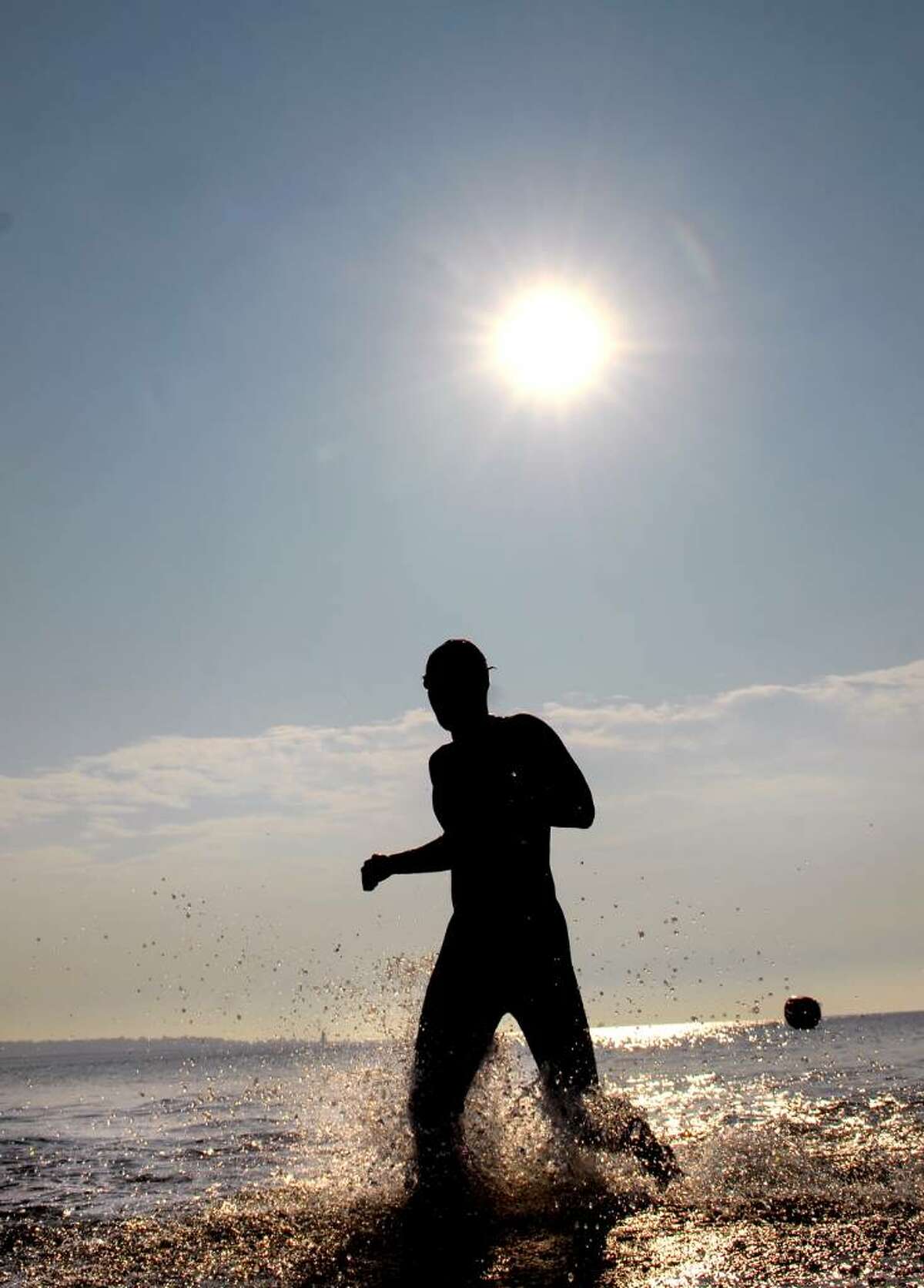 A swimmer exits Long Island Sound during the Greenwich Point 1-mile swim, Saturday morning, July 17, 2010.