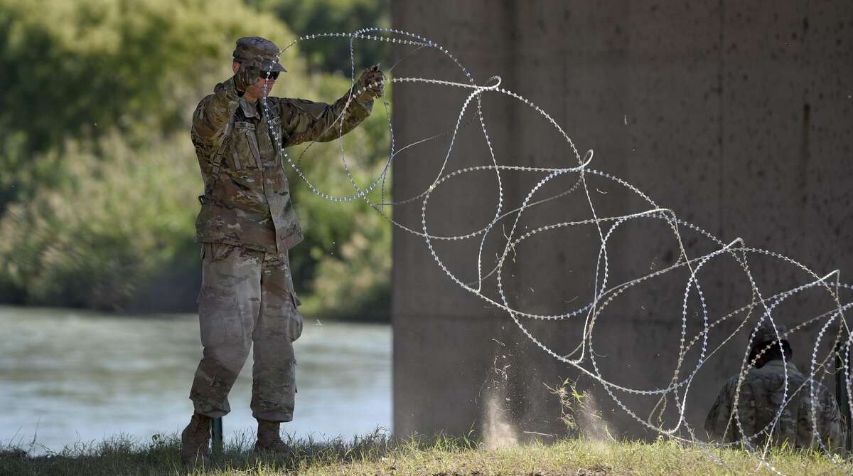 The U.S. military installs barbed concertina wire along the banks of the Rio Grande on Friday, Nov. 16, 2018 as they reinforce the border and ports of entry in Laredo, Texas.