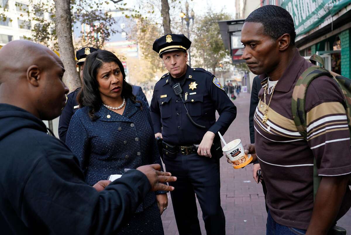 Homeless Outreach Team counselor Elester Hubbard (left) and Mayor London Breed (second from left) talk with Ebony Holt while working with a Healthy Streets Operation Center team in San Francisco.