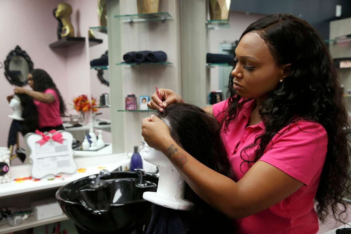 Lani La’Flare prepares hair extensions from Mayvenn before a client arrives for an appointment at her salon in El Cerrito, Calif. on Friday, Nov. 16, 2018.