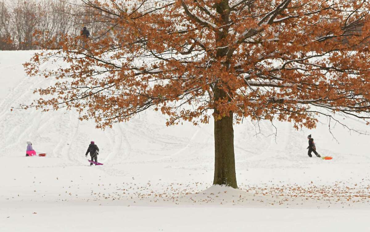 Click through the photo gallery to see "first snows" of years gone by. Sledders enjoy a hill at Frear Park after the Capital Region's first snow storm on Friday, Nov. 16, 2018 in Troy, N.Y. (Lori Van Buren/Times Union)
