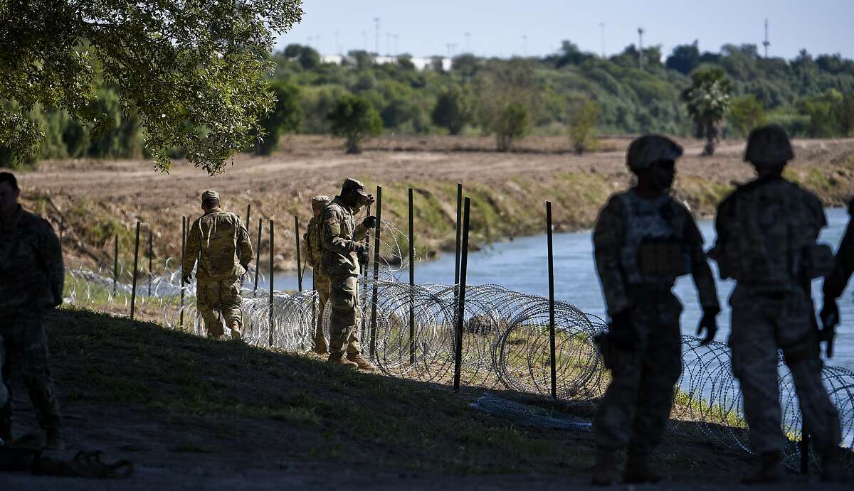 The U.S. military installs concertina wire along the banks of the Rio Grande on Friday, Nov. 16, 2018 as they reinforce the border and ports of entry in Laredo, Texas.