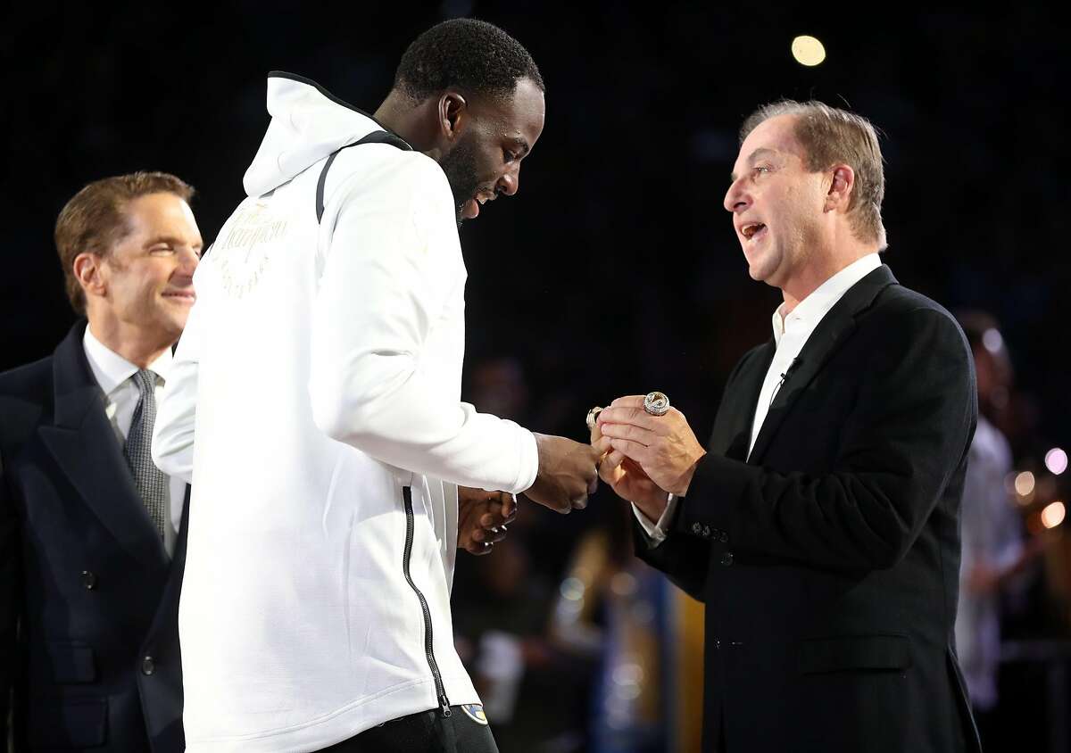 Golden State Warriors' Draymond Green receives his 2018 NBA Championship ring from owner Joe Lacob during a ceremony before Opening Night game against Oklahoma City Thunder at Oracle Arena in Oakland, Calif. on Tuesday, October 16, 2018.