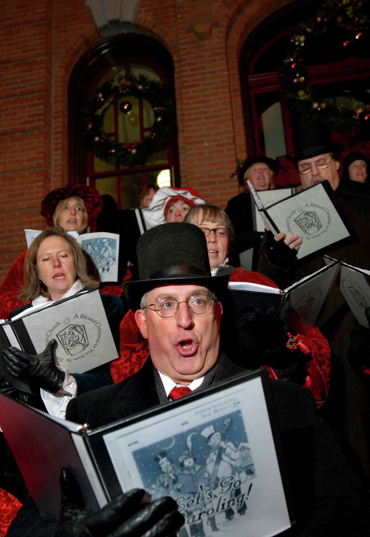 CINDY SCHULTZ/TIMES UNION -- Dave Herman, center, sings Christmas carols with the St. Paul Lutheran Church Victorian Singers during the 22nd Annual Victorian Streetwalk on Thursday, Dec. 4, 2008, in front of City Hall in Saratoga Springs, N.Y.