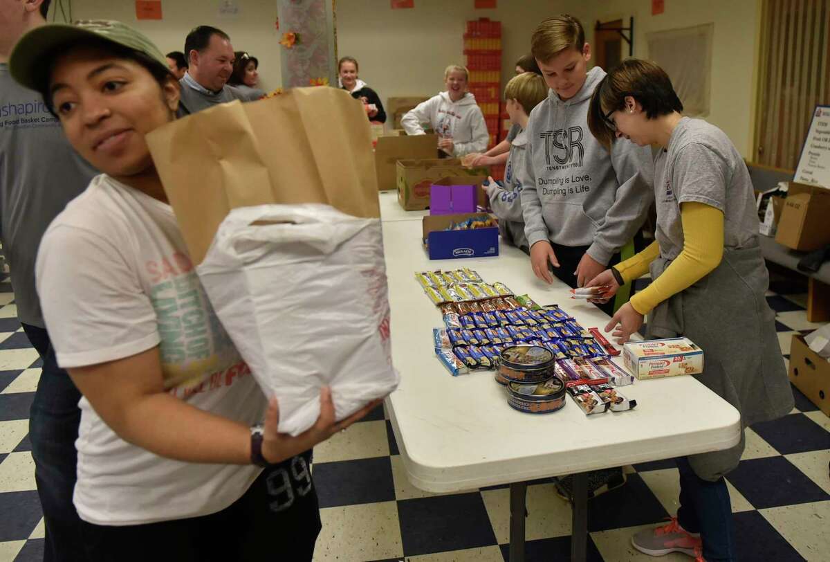 New Haven, Connecticut, November 17, 2018: More than 30 blumshapiro employees and their families, community volunteers and Christian Community Action employees help Christian Community Action of New Haven prepare hundreds of bags of Thanksgiving Day meals Saturday during the seventh annual blumshapiro Thanksgiving Food Basket Campaign for Christian Community Action at Casa de Adoracion y Oracion on Columbus Avenue in New Haven. The annual volunteer food campaign will feed more than 1,200 New Haven families and 3,000 residents.