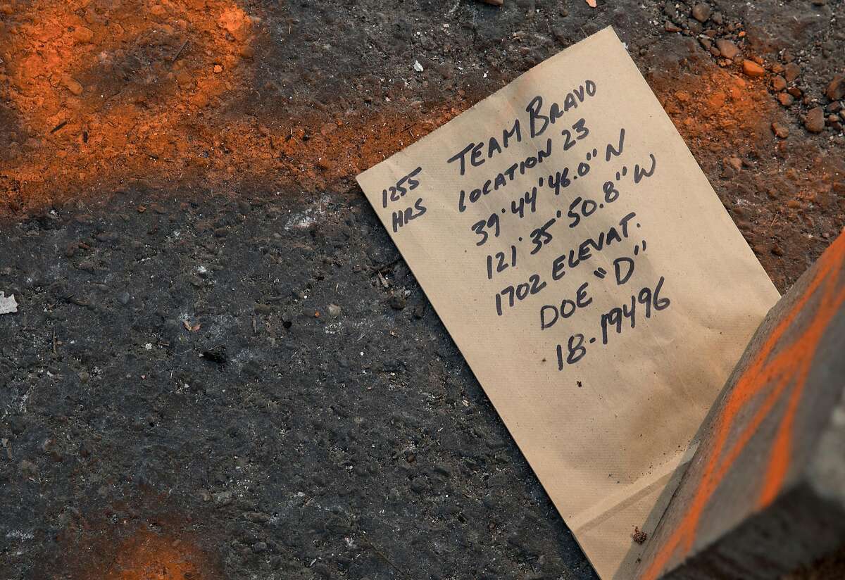 A note marking the discovery of human remains sits in the driveway of a charred home in Holly Hills Mobile Estates in Paradise, Calif. Saturday, Nov. 17, 2018 after the Camp Fire ripped through the town, destroying most structures.