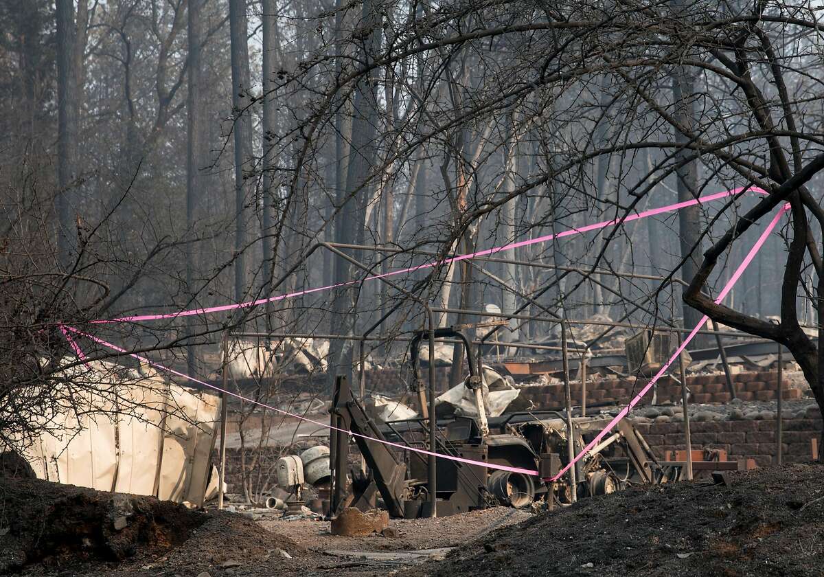 Caution tape surrounds an area where human remains were found inside a charred home in Holly Hills Mobile Estates in Paradise, Calif. Saturday, Nov. 17, 2018 after the Camp Fire ripped through the town, destroying most structures.