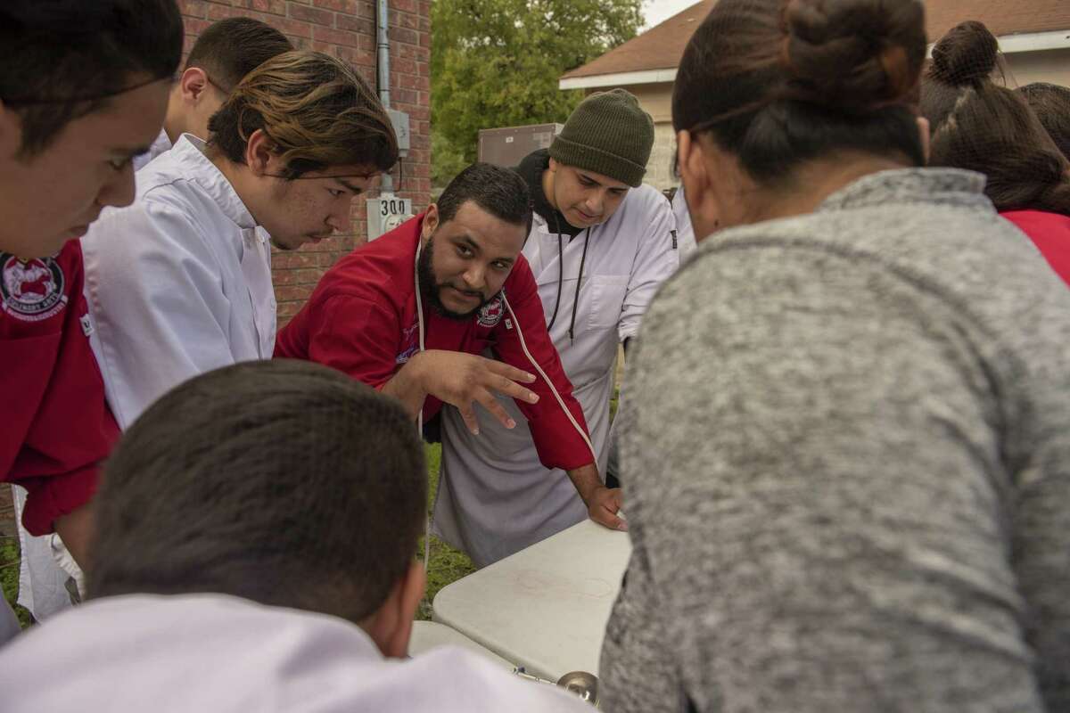 Southside High School instructor and chef Angel Machado, huddles with students before serving a gourmet Thanksgiving meal for 350 families in need on Saturday, November 17, 2018.. The students' meal will include turkeys, pies and traditional fixings. Southside ROTC students helped raise money for cans of food and turkeys.