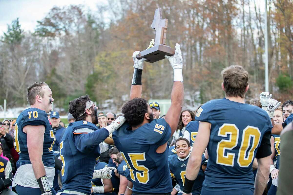 Choate Captains Clay Zachery (15), Spencer Witter (20), Hunter Burns (5) and James McCarthy (70) share the Championship Trophy with their team during the Mike Silipo Bowl between Choate and Brunswick on November 17, 2018 at Choate Rosemary Hall in Wallingford, CT.