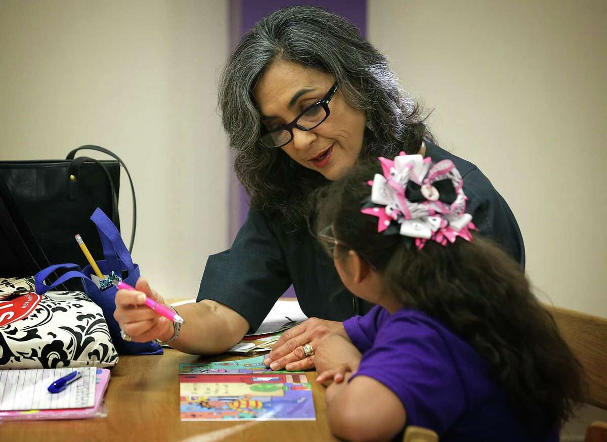 Melva Manzke, a Reading Buddy with the San Antonio Public Library program Youth Literacy, works with a student from Graebner Elementary School on Wednesday, Nov. 18, 2015.