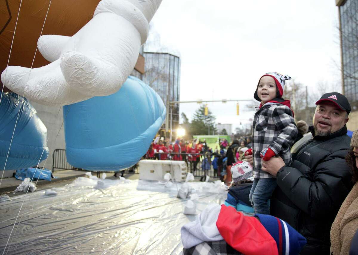 Mathew Rito, 4, and his dad, Julio, of White Plains, N.Y., look at the balloons during the Point72 Giant Balloon Inflation Party, a precursor to the Stamford Downtown Parade Spectacular, in Stamford on Saturday.