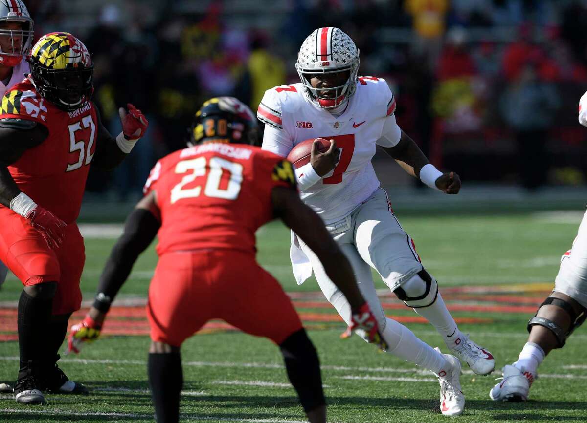Ohio State quarterback Dwayne Haskins Jr. (7) runs with the ball against Maryland defensive back Antwaine Richardson (20) and defensive lineman Oluwaseun Oluwatimi (52) during the first half of an NCAA football game, Saturday, Nov. 17, 2018, in College Park, Md. (AP Photo/Nick Wass)