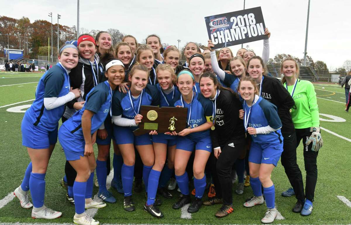 Members of the Lewis Mills girls soccer team celebrate their win in the Class M championship on Sunday in West Haven.