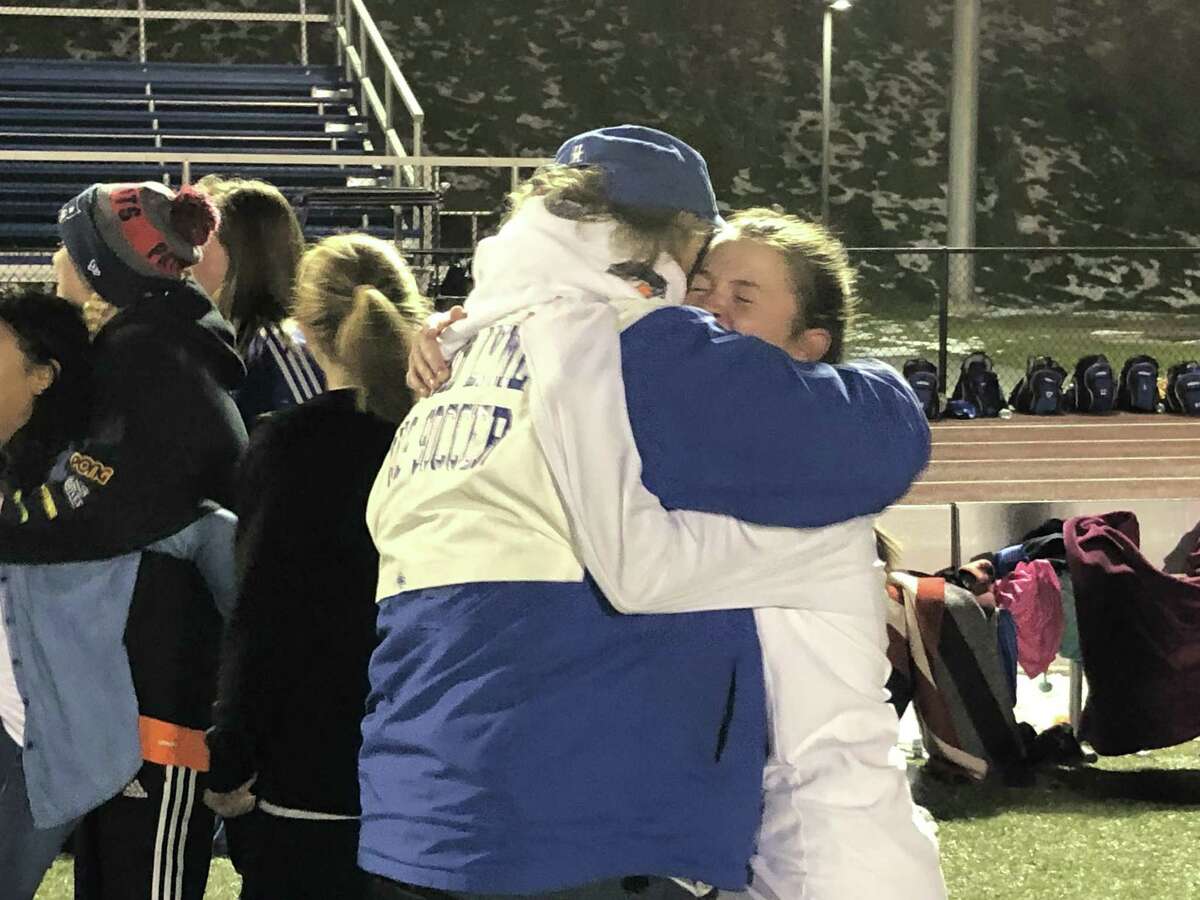 Old Lyme’s Mya Johnson, the game MVP, hugs coach Paul Gleason after Sunday’s win in the Class S girls soccer championship game.