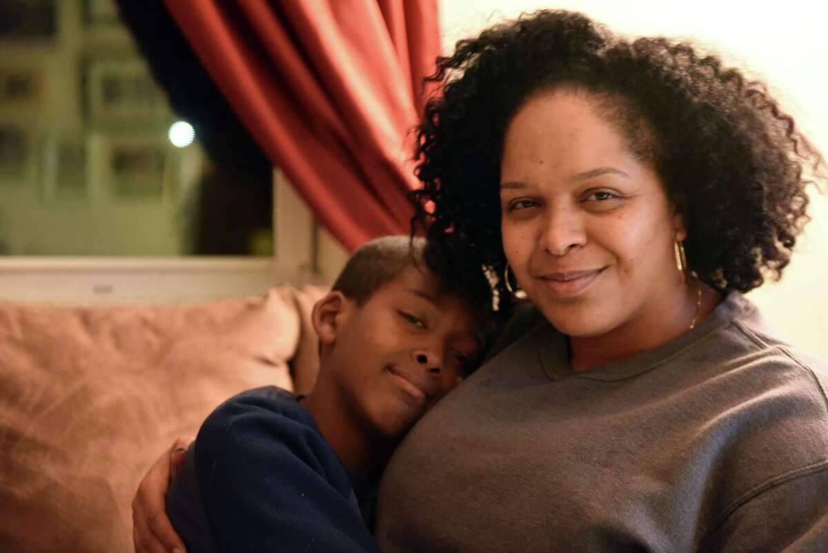 Dalila Yeend with her son, Taki Evans, 9, at their home on Wednesday, Nov. 14, 2018, in Troy, N.Y. Yeend, a single mother and domestic violence survivor, can't receive cash public benefits while she's applying for a green card to legalize her undocumented immigration status. The federal government has proposed tightening restrictions on which immigrants receiving public benefits are eligible to apply for green cards - expanding the definition to include non-cash benefits like food stamps. (Will Waldron/Times Union)