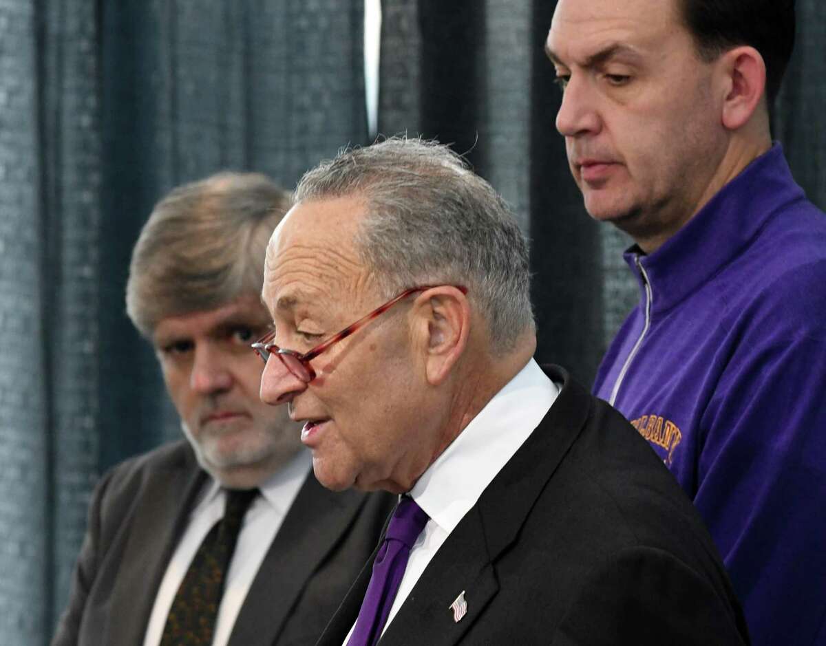 Sen. Charles Schumer, center, is accompanied by University at Albany basketball coach Will Brown, right, and Bill McGee, an aviation and travel consultant for Consumer Reports, during a press conference to demand that the Federal Aviation Administration begin the process of tackling shrinking passenger seat room on airplanes on Monday, Nov. 19, 2018, at Albany International Airport in Colonie, N.Y. Sen. Schumer passed a law requiring the FAA to address the issue earlier this summer, but has yet to see any progress. The law gives the FAA a year to address the issue and provide notice and opportunity for the public to chime in. (Will Waldron/Times Union)