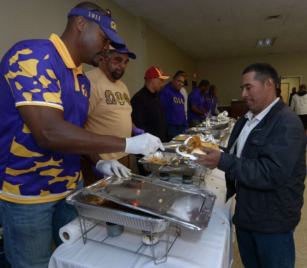Omega Psi Phi alumni serve food during the South Norwalk Community Association annual Thanksgiving Day meal Thursday, November 23, 2017, at the South Norwalk Community Center in Norwalk, Conn.