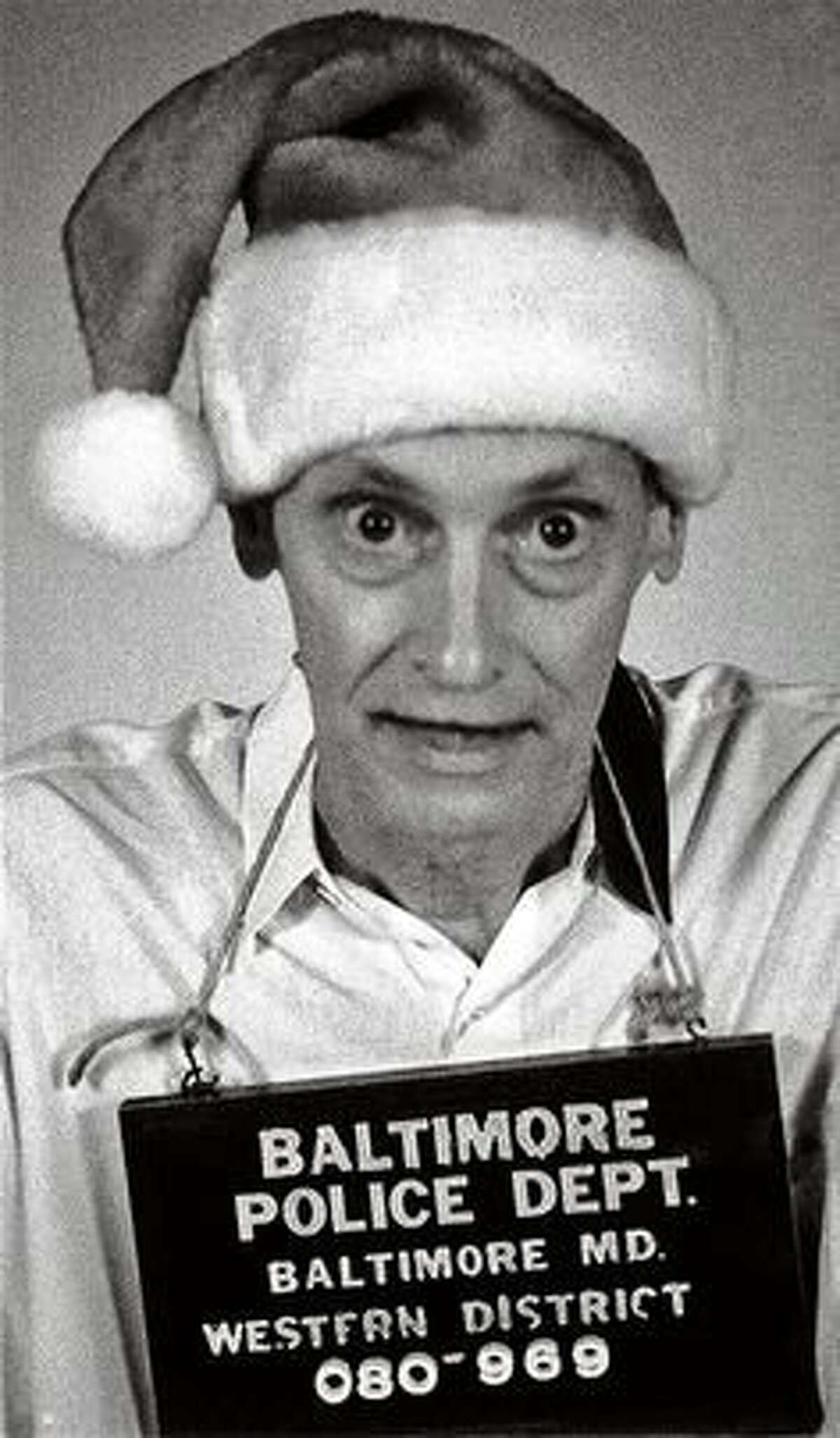 A fake mugshot by the Baltimore Police John Waters used one year as the image for his Christmas card.