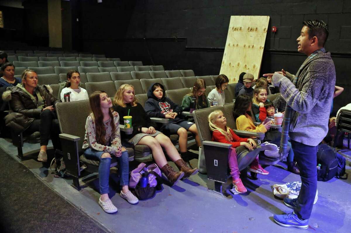 Christopher Rodriguez, director, instructs the young cast members before a rehearsal for “Annie” at the Woodlawn Theatre.
