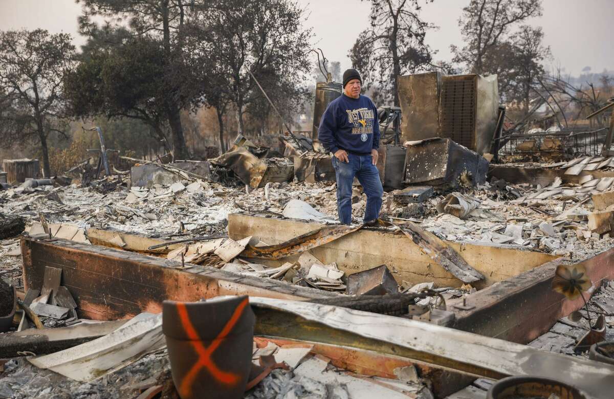 John Wiggins stands on his destroyed property after the Camp Fire raged through in Paradise.