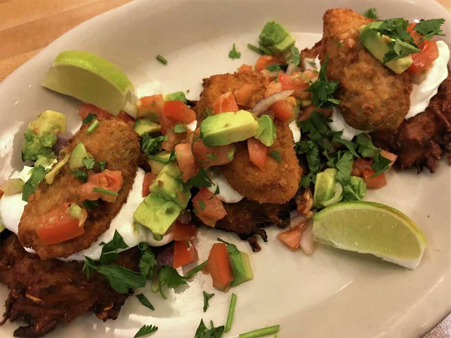 Kenny & Ziggy's New York Delicatessen restaurants will offer Enchilatkes during Hanukkah 2018. The Tex-Mex dish is made with potato latkes topped with cheese-stuffed jalapenos, sour cream and pico de gallo. Photo: Kenny & Ziggy's