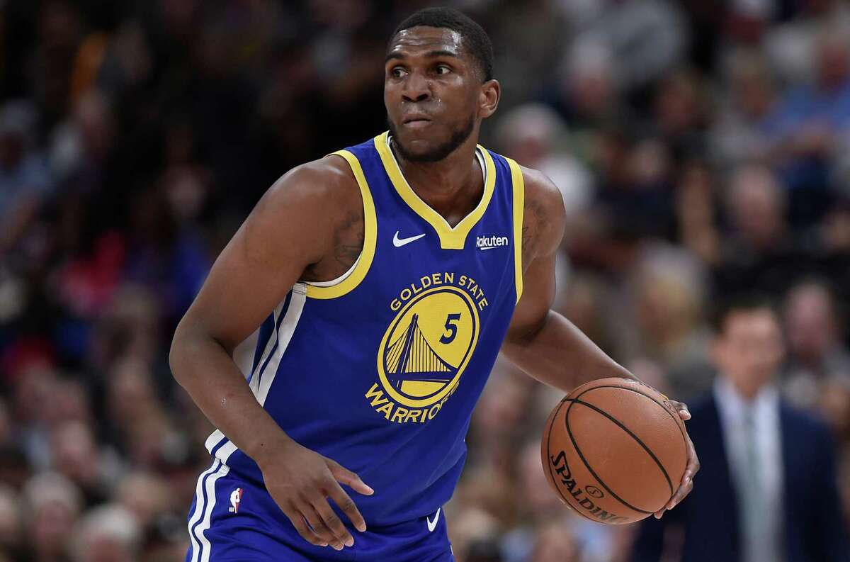 Kevon Looney of the Golden State Warriors controls the ball in a NBA game against the Utah Jazz at Vivint Smart Home Arena on October 19, 2018 in Salt Lake City, Utah.