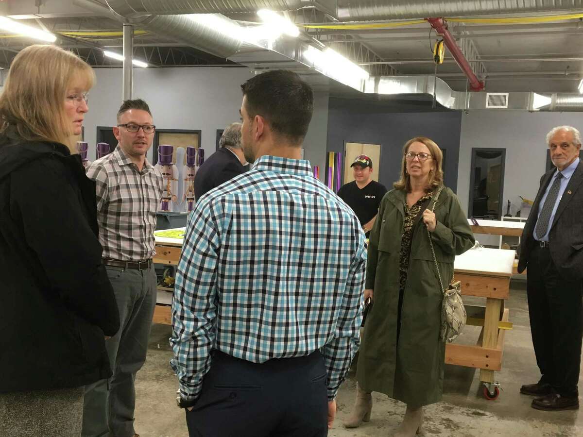 Pinpoint Promotions, which on Oct. 15 opened a new facility in a long-vacant warehouse building at 45 Railroad Ave. in West Haven, invited city officials and state representatives to tour the facility on Tuesday, Nov. 20, 2018. Here, Pinpoint Managing Partner Steve Gentile, center, talks to West Haven Mayor Nancy Rossi. In the background, from left, are Pinpoint Managing Partner TJ Andrews, state Rep. Charles Ferraro, R-West Haven, a Pinpoint employee, state Rep. Dorinda Borer, D-West Haven, and mayoral Executive Assistant Louis Esposito.