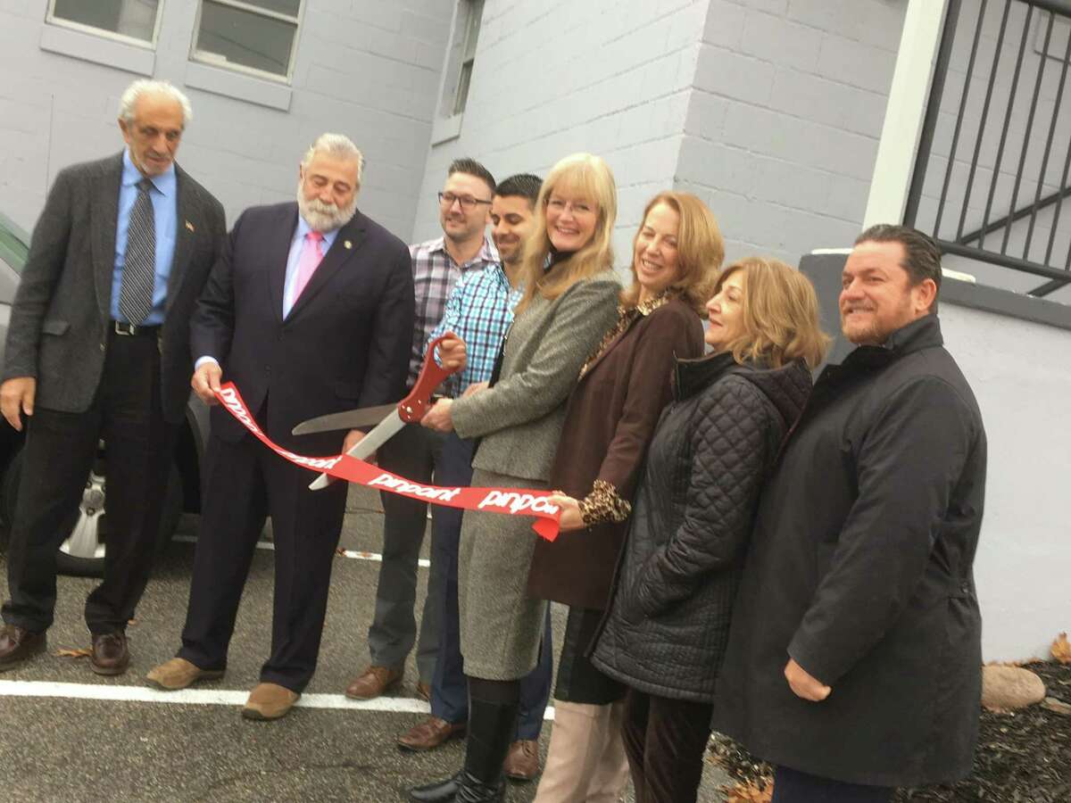 Pinpoint Promotions, which on Oct. 15 opened a new facility in a long-vacant warehouse building at 45 Railroad Ave. in West Haven, invited city officials and state representatives to tour the facility on Tuesday, Nov. 20, 2018. Afterward, they did a ceremonial ribbon-cutting. From left, mayoral Executive Assistant Louis Esposito, state Rep. Charles Ferraro, R-West Haven, Pinpoint managing partners TJ Andrews and Steve Gentile, West Haven Mayor Nancy Rossi, state Rep. Dorinda Borer, D-West Haven, City Clerk Deborah Collins and Commissioner of Planning & Development Fred A. Messore.